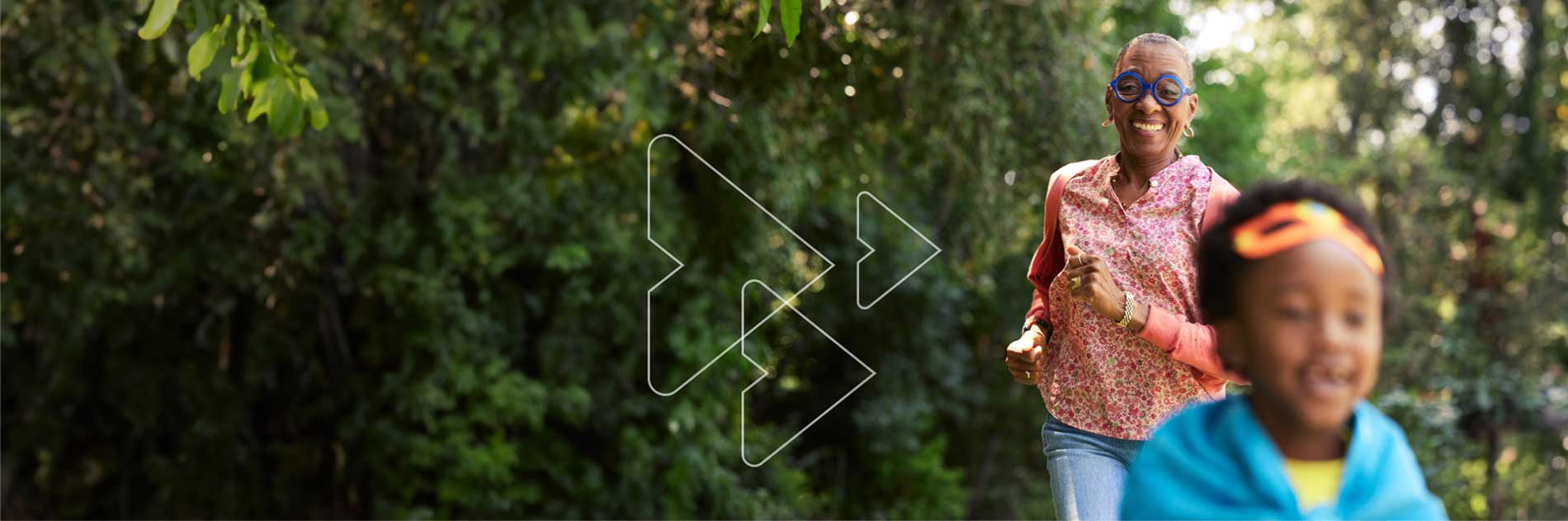 A smiling WATCHMAN patient chasing her grandchild through the forest.